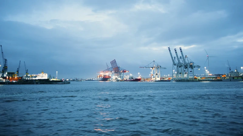 Standbild aus „Port of Hamburg“: Containerkräne in der Abenddämmerung über der Elbe